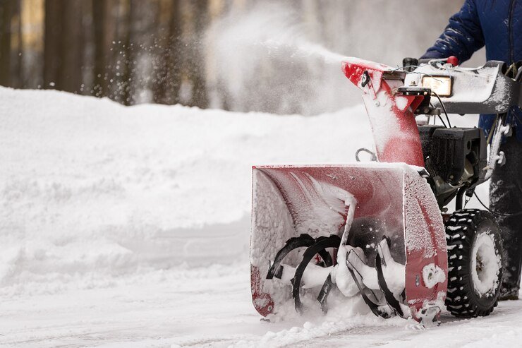 The 2-stage system, which uses an auger and impeller, gathers snow and blows it farther away